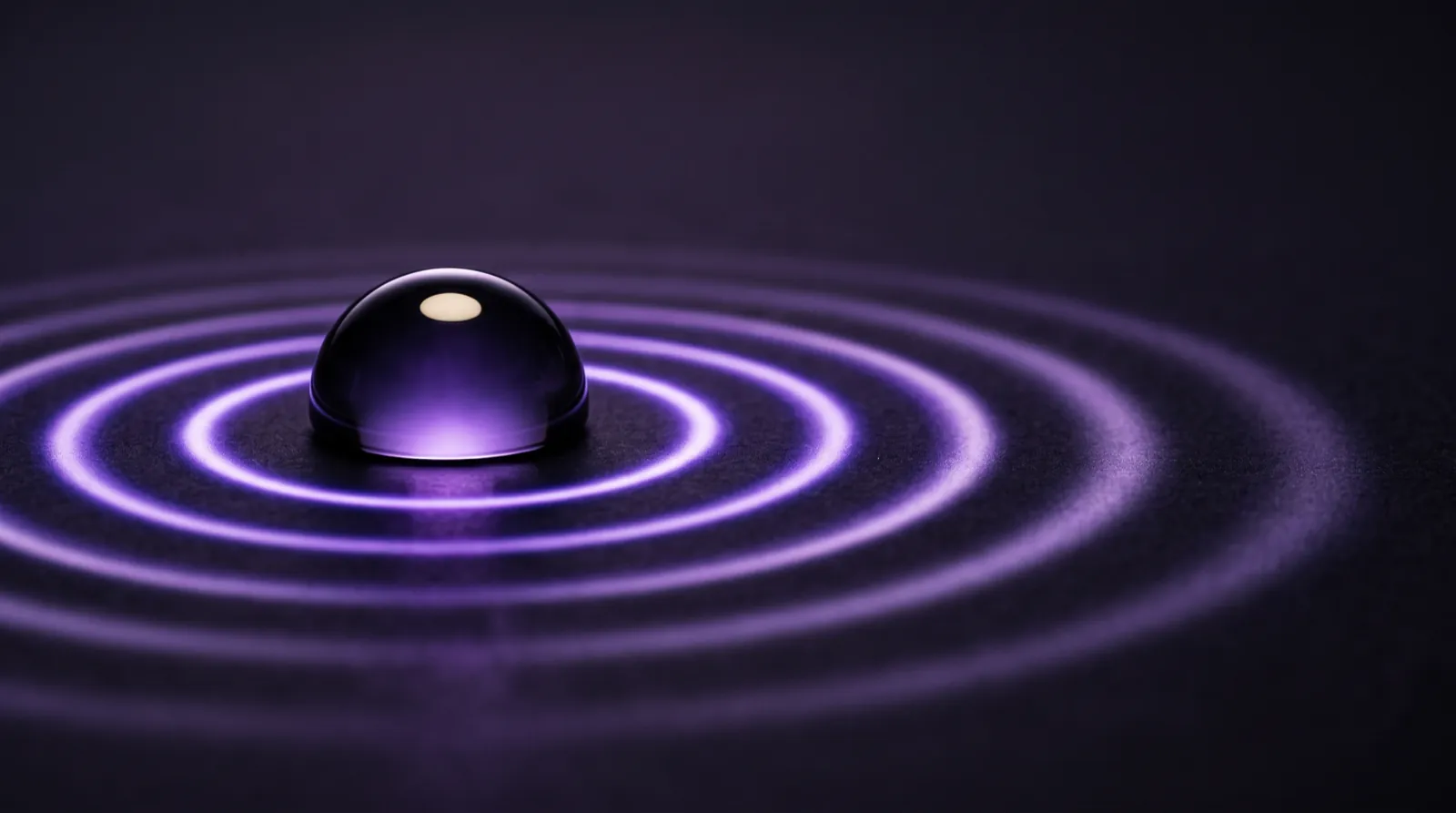 A polished glass hemisphere emitting calm concentric rings of violet light — a pulse, watched.